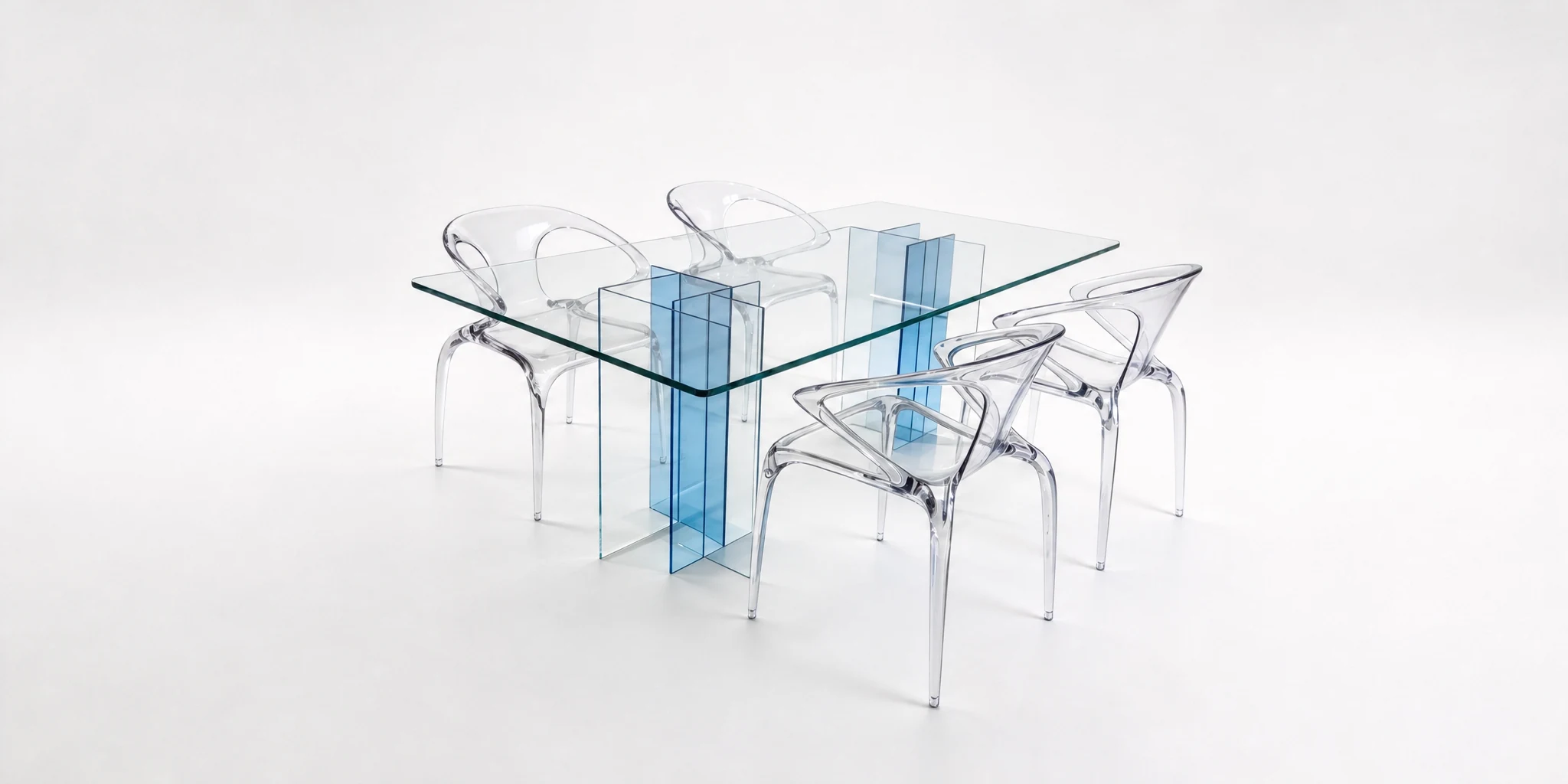 Clear acrylic dining table with blue-tinted legs and moulded chairs