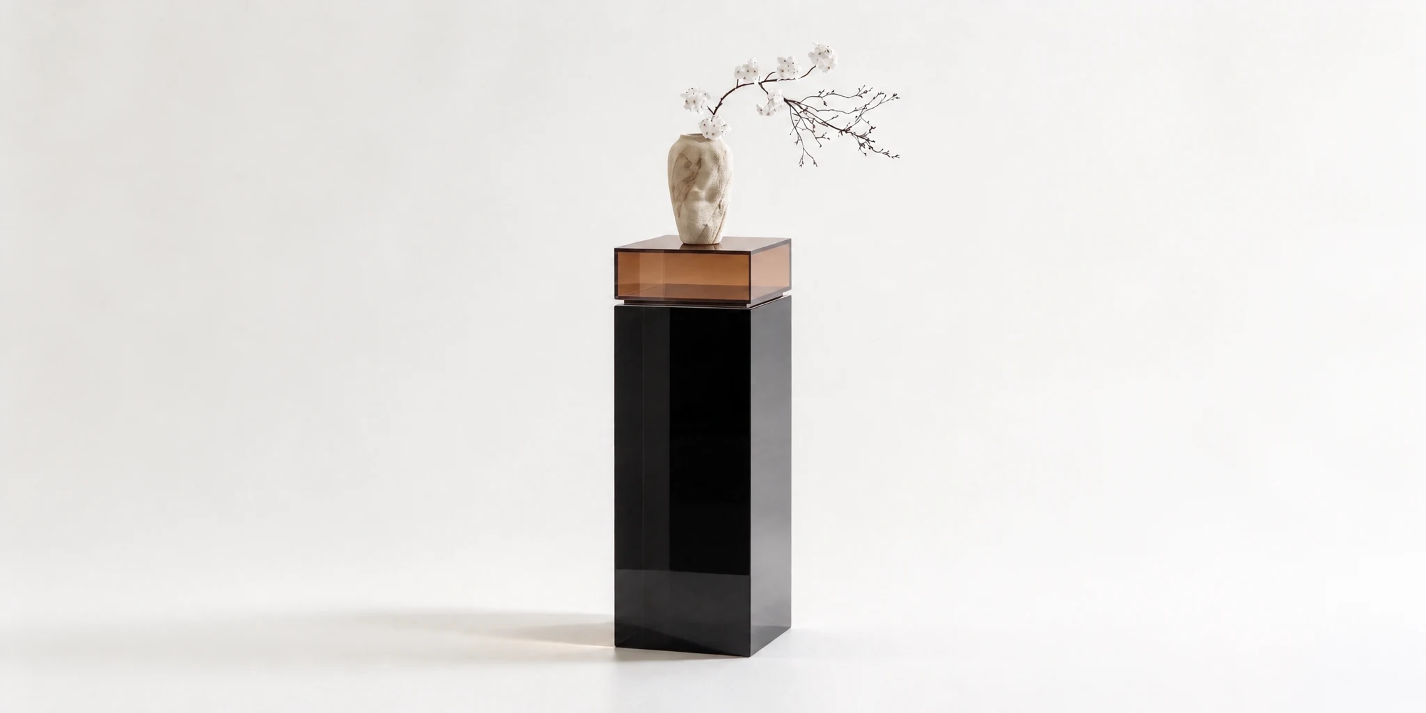Black acrylic display plinth with a wood top holding a sculpture