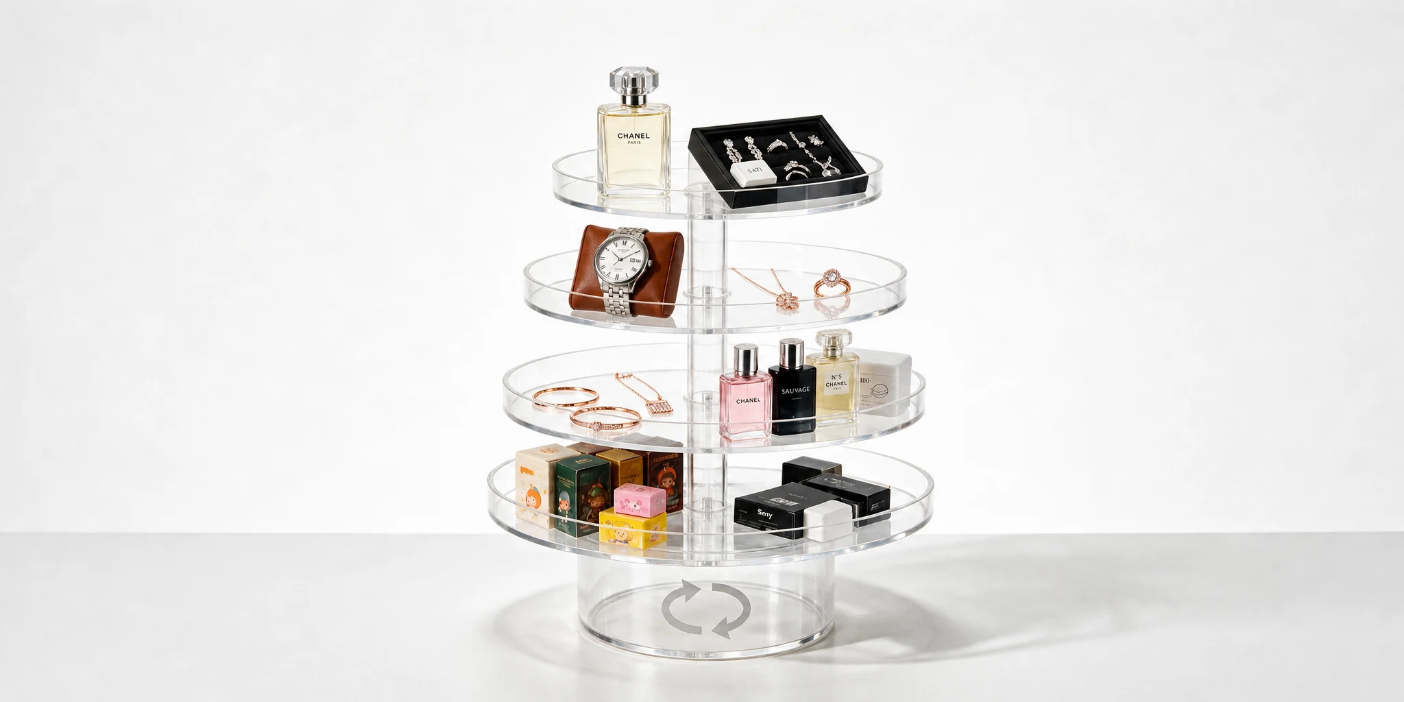 Round rotating multi-tier acrylic display stand holding perfume and jewellery