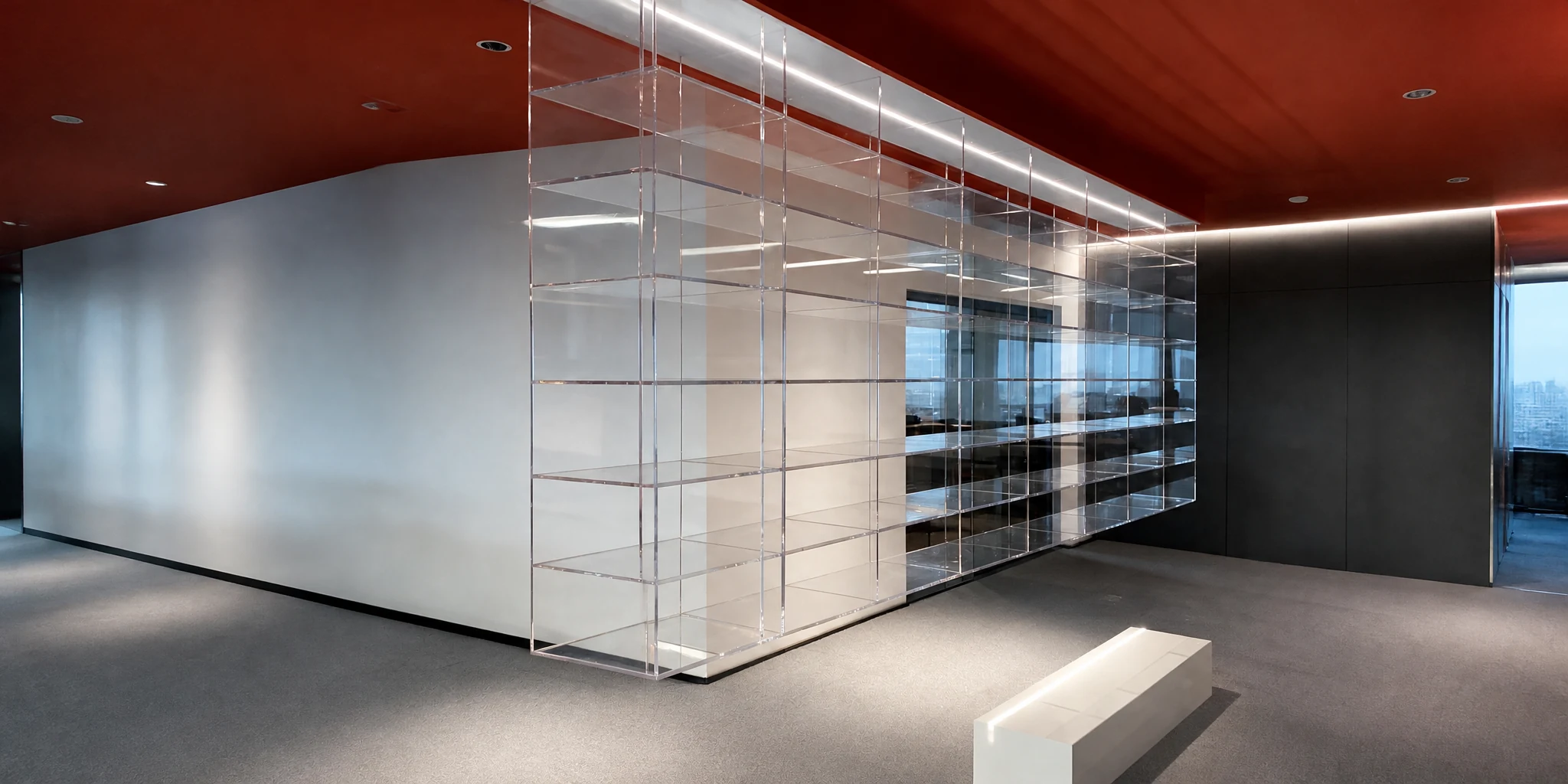 Large suspended acrylic display cabinet hung from a ceiling in a showroom